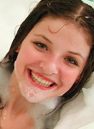 Adorable teen having fun in a bubble bath